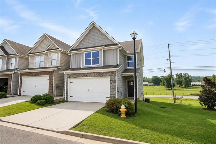 Modern two-story residence with a concrete driveway and an attached garage