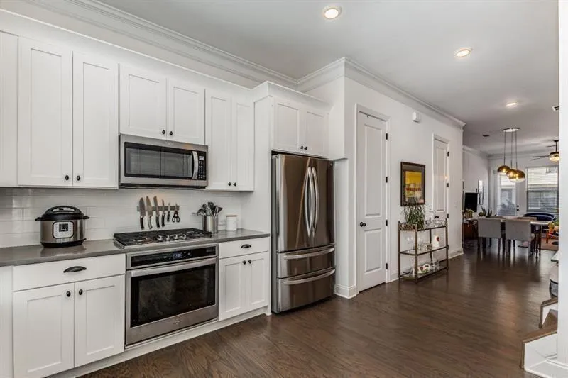 Kitchen featuring dark wood floors, gleaming like-