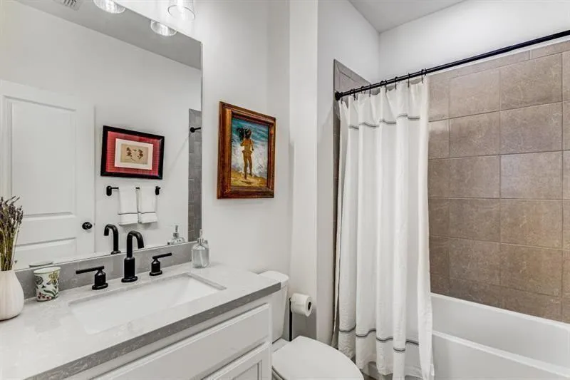 Lower level full bathroom features on-trend vanity