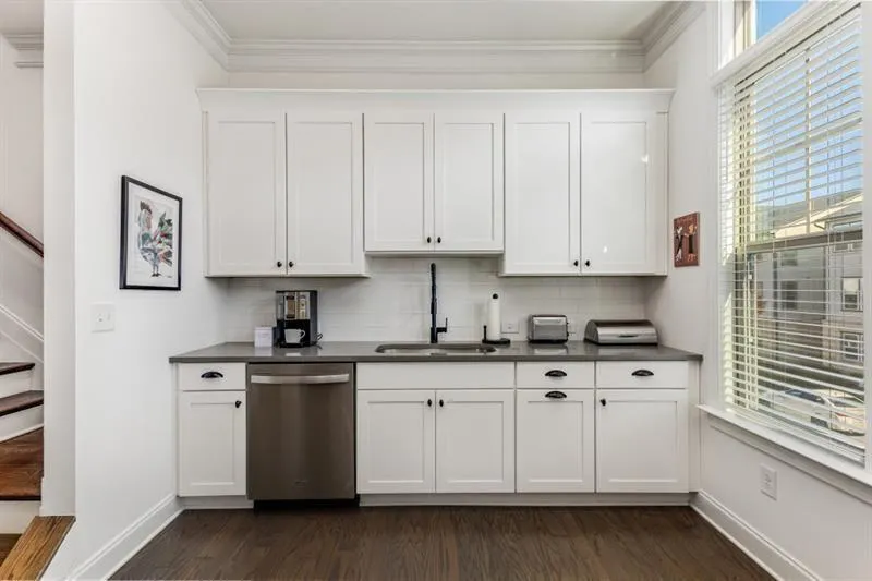 Kitchen features on trend white custom cabinetry,