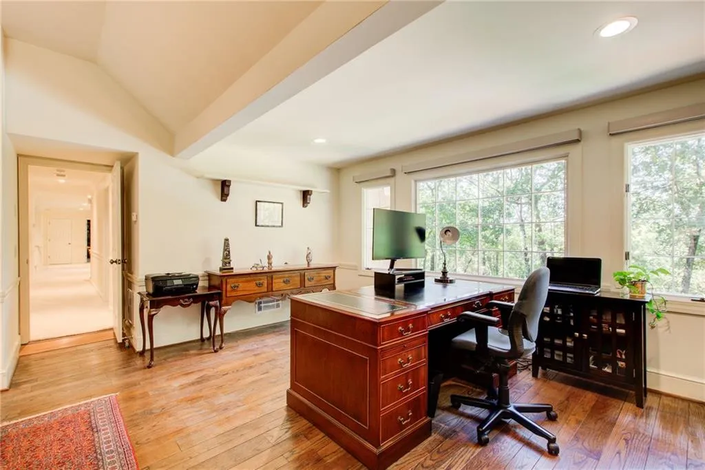 Office area with light wood-style floors, recessed lighting, and vaulted ceiling Office area with light wood-style floors, recessed lighting, and vaulted ceiling