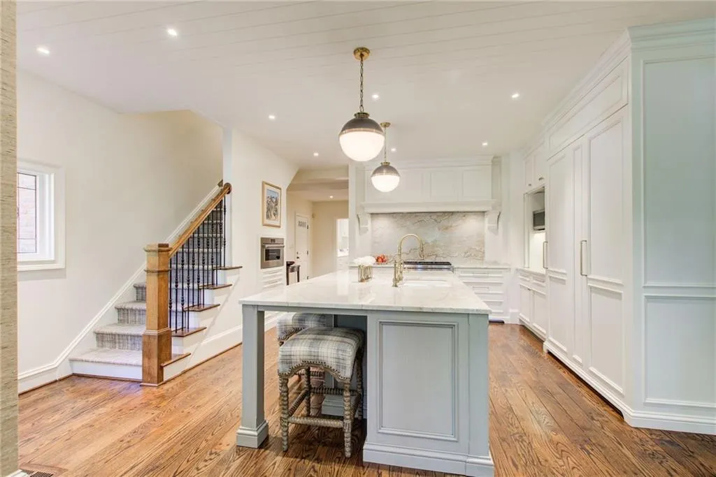 Kitchen featuring pendant lighting, light stone counters, dark wood finished floors, recessed lighting, and white cabinets Kitchen featuring pendant lighting, light stone counters, dark wood finished floors, recessed lighting, and white cabinets