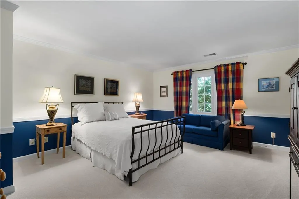 Bedroom featuring ornamental molding and carpet flooring Bedroom featuring ornamental molding and carpet flooring