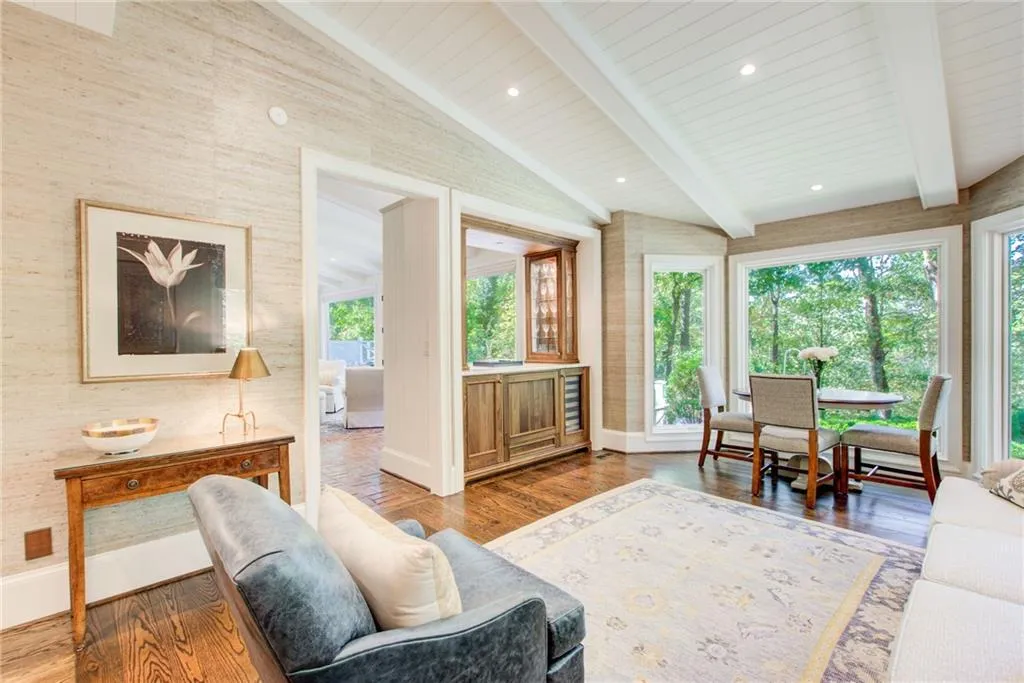 The keeping room has a custom bar area, floor to ceiling windows,  a beautiful  beamed ceiling and hardwood flooring. The keeping room has a custom bar area, floor to ceiling windows,  a beautiful  beamed ceiling and hardwood flooring.