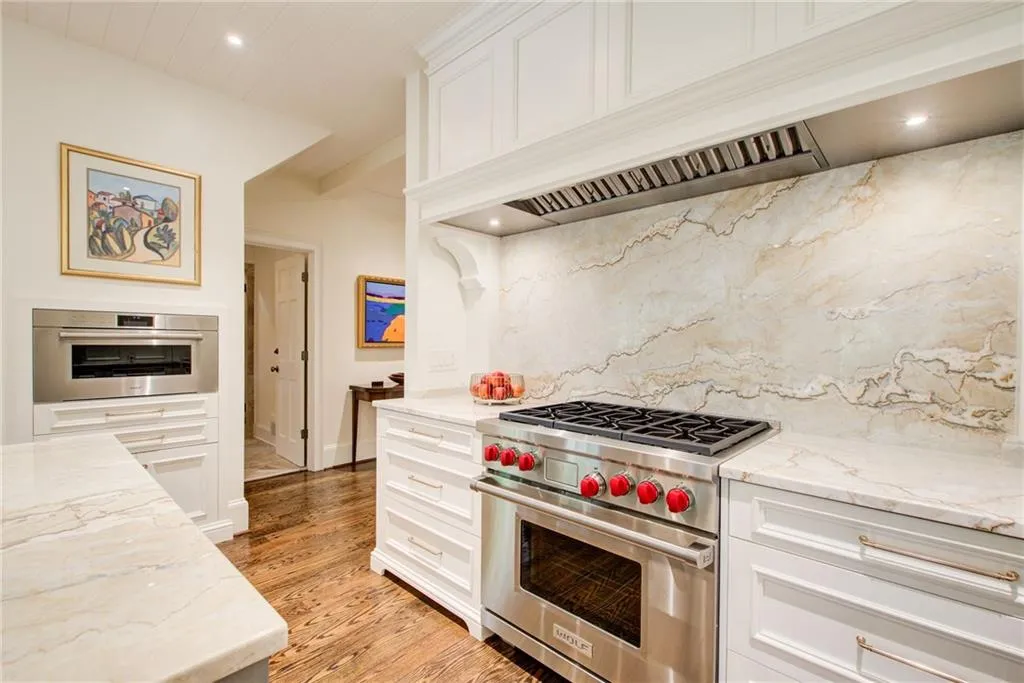 A chef's kitchen including a Wolf cooktop and oven. A chef's kitchen including a Wolf cooktop and oven.