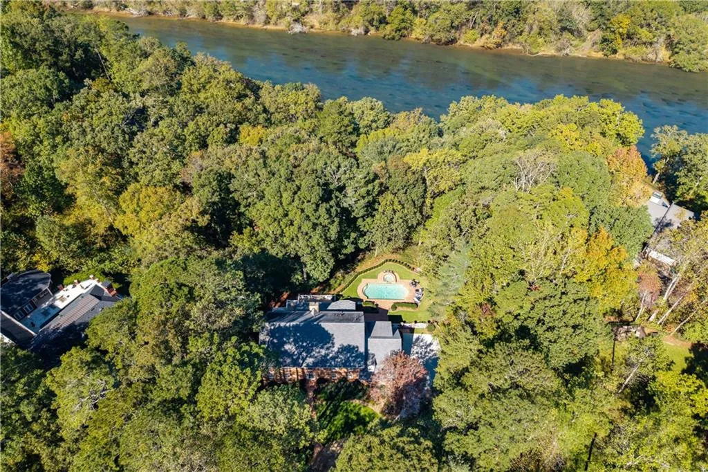 Aerial view of a large body of water and a heavily wooded area Aerial view of a large body of water and a heavily wooded area