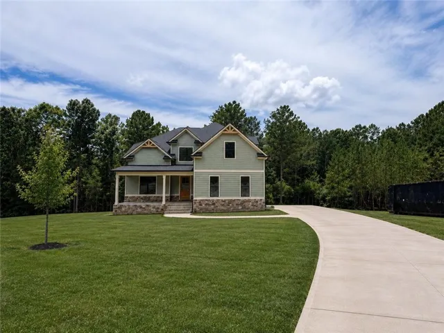 Picture is of home. Driveway and yard is AI.