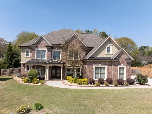 Craftsman house with brick siding and a standing seam roof