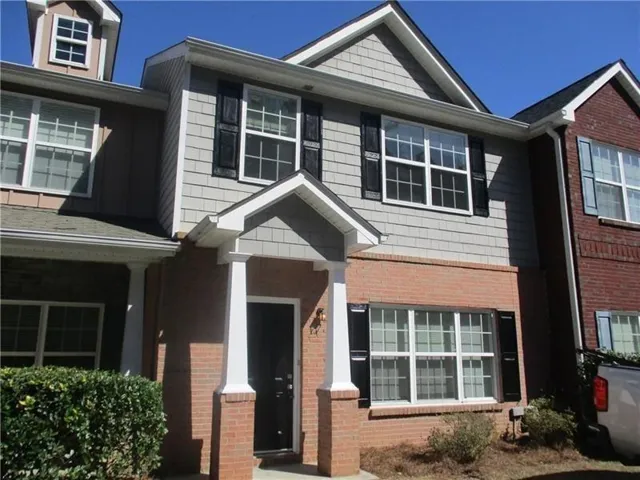 Brick and siding exterior with gabled roofline and dormer