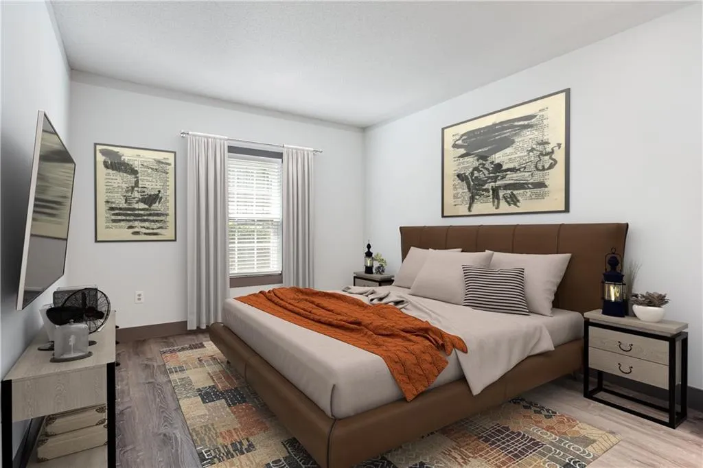 Bedroom with wood finished floors and baseboards