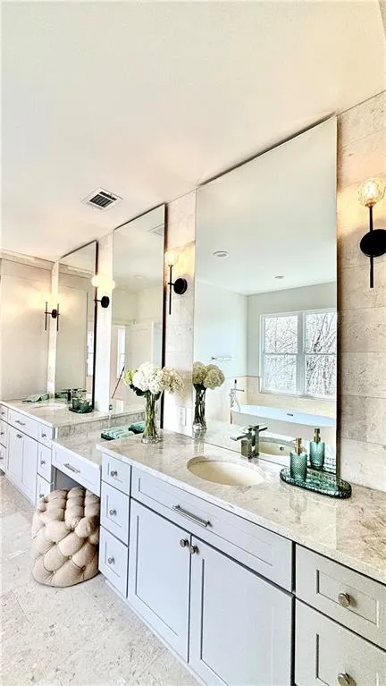 Bathroom with vanity and a garden tub