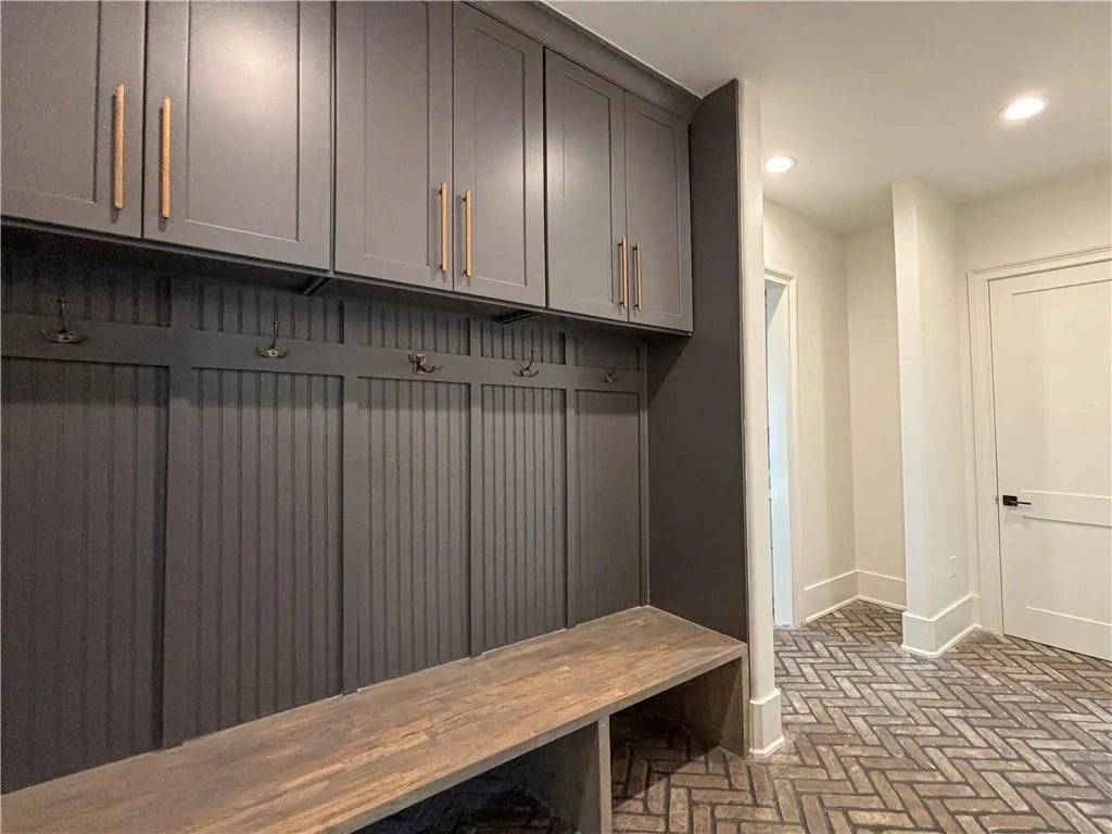 Mudroom featuring brick floors and recessed lighting