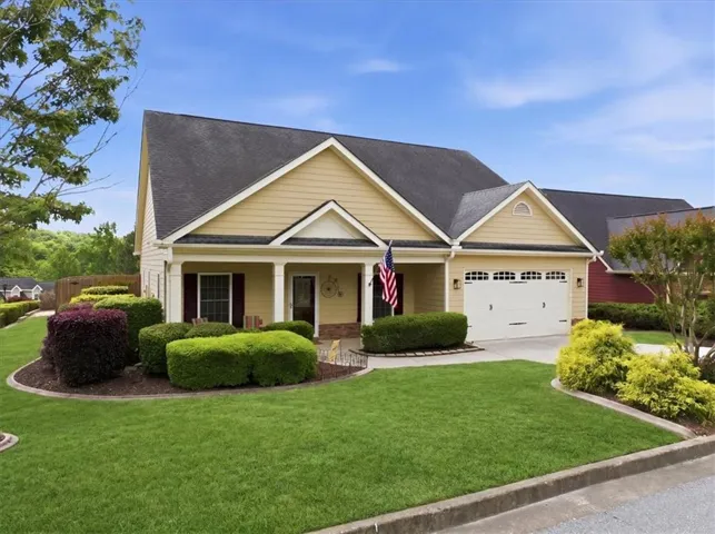 Yellow siding exterior with white trim and dark roofing