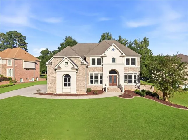 Stately brick and stone facade with a multi-gabled roofline