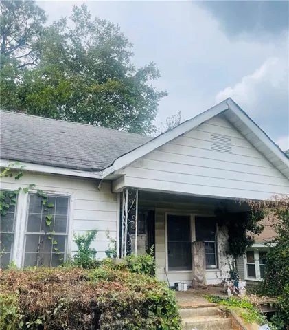 Bungalow with a porch and roof with shingles