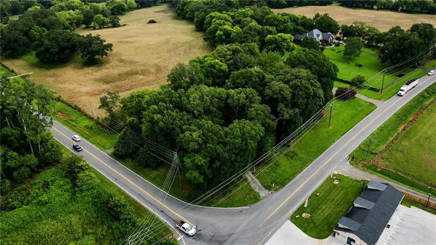 Rural landscape featuring paved roads and abundant mature trees