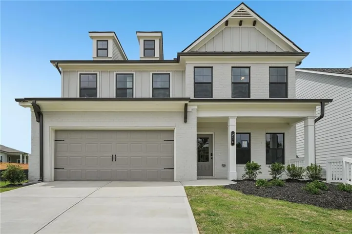 Two-story residential structure featuring light gray painted brick and vertical siding