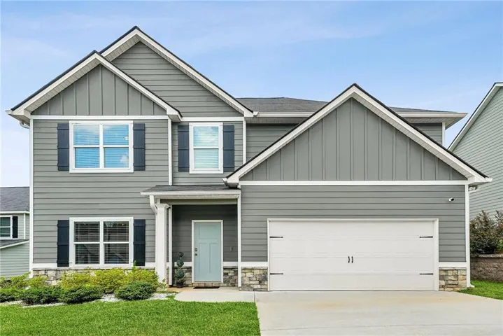 Contemporary two-story residence featuring grey horizontal siding and vertical board and batten accents