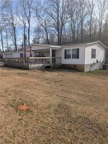 Manufactured / mobile home featuring crawl space, a front yard, and a wooden deck