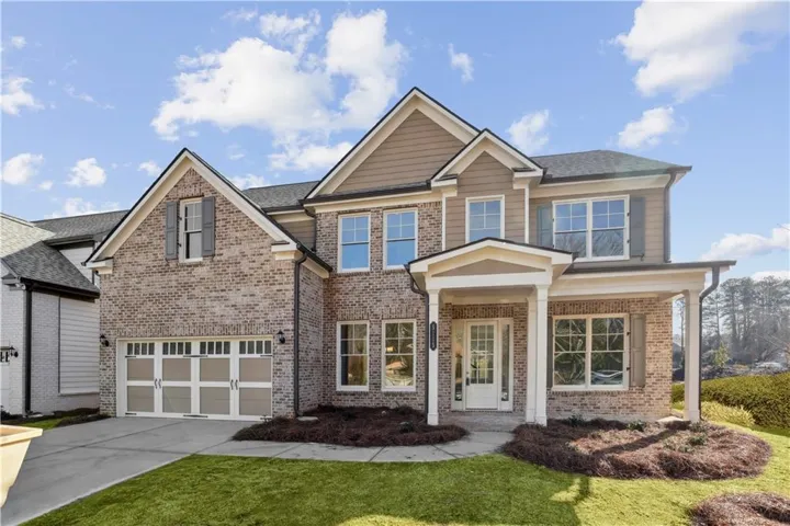 EXAMPLE PHOTOS of this plan. Actual home is under construction. Two-story brick and siding construction with a covered front entry