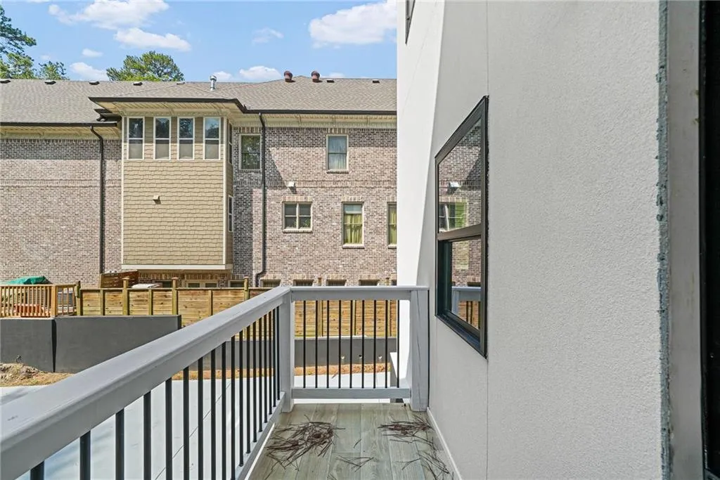 Balcony featuring composite decking and a black and white railing