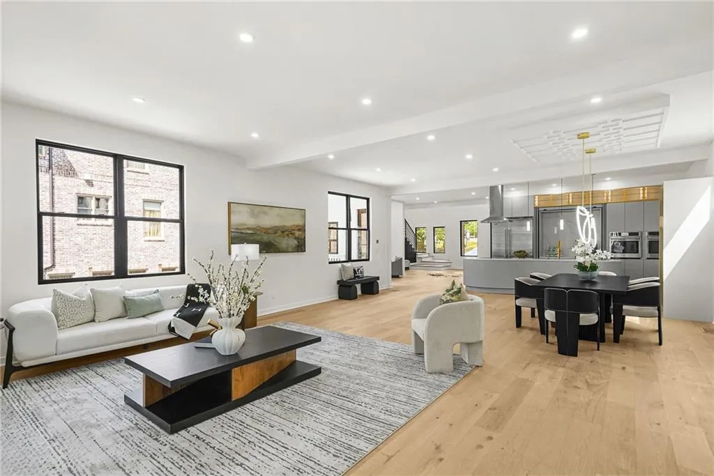 Recessed lighting illuminates wood-finish flooring throughout the open-concept space