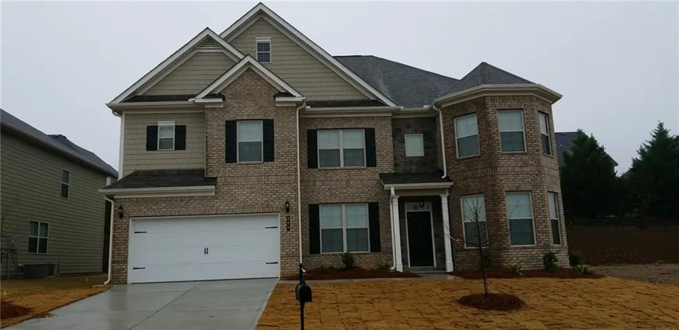 Brick and siding exterior with a two-car garage
