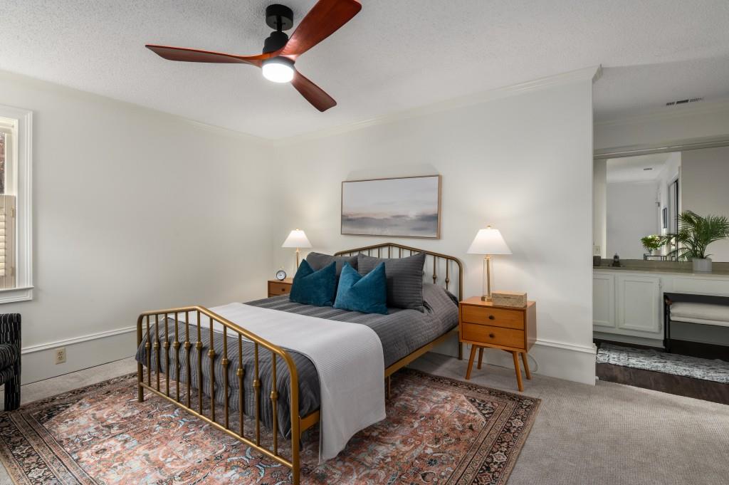 Primary suite with ample closet space & updated bathroom featuring double vanities and redone shower.