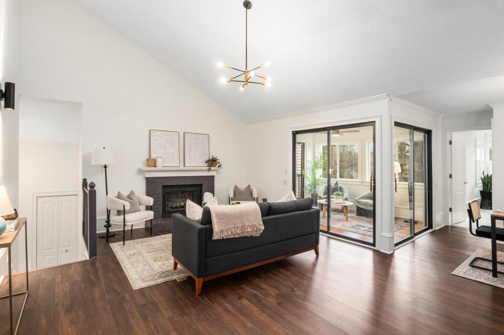 The living room is a cozy haven with a working fireplace and views to the dining area and kitchen.