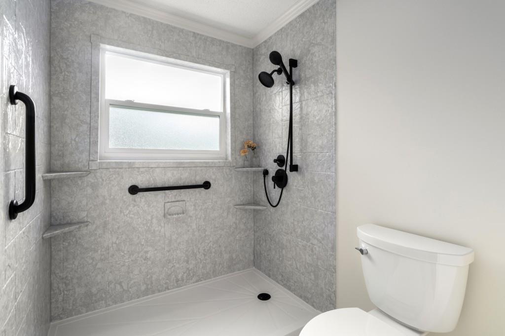 Primary suite with ample closet space & updated bathroom featuring double vanities and redone shower.