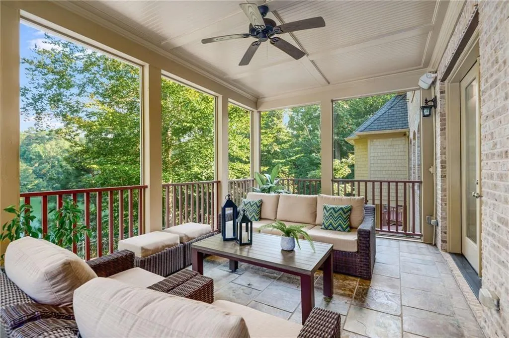 Screened Porch with tile flooring overlooking the pool and lake