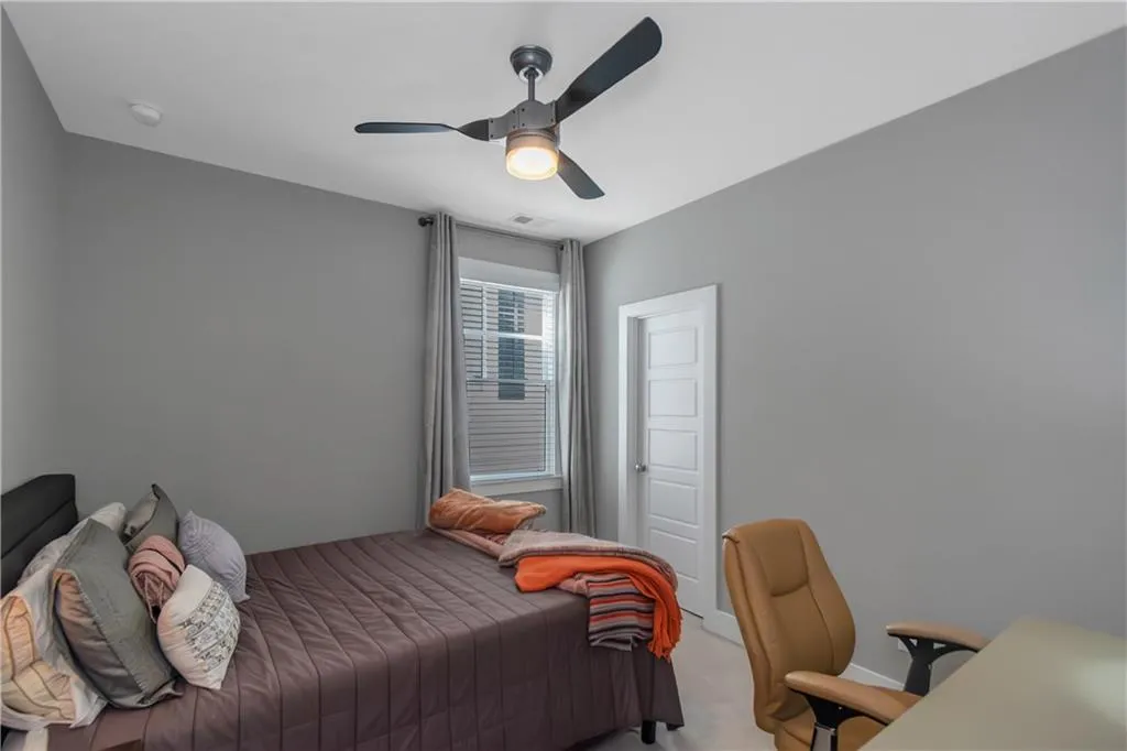 Bedroom featuring carpet floors, a ceiling fan, and visible vents