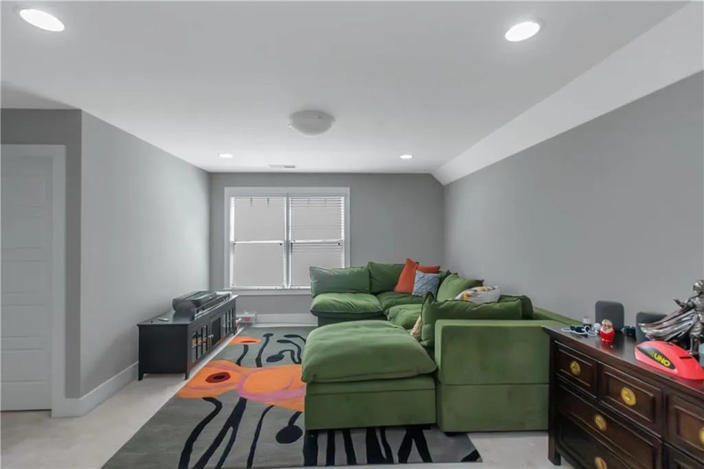 Living room with recessed lighting, baseboards, and light carpet