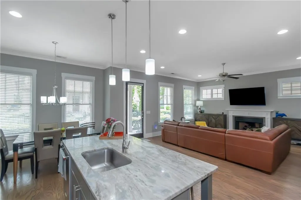Kitchen featuring recessed lighting, plenty of natural light, a sink, and wood finished floors