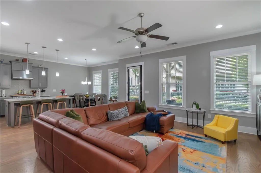 Living area featuring ceiling fan, light wood finished floors, and recessed lighting