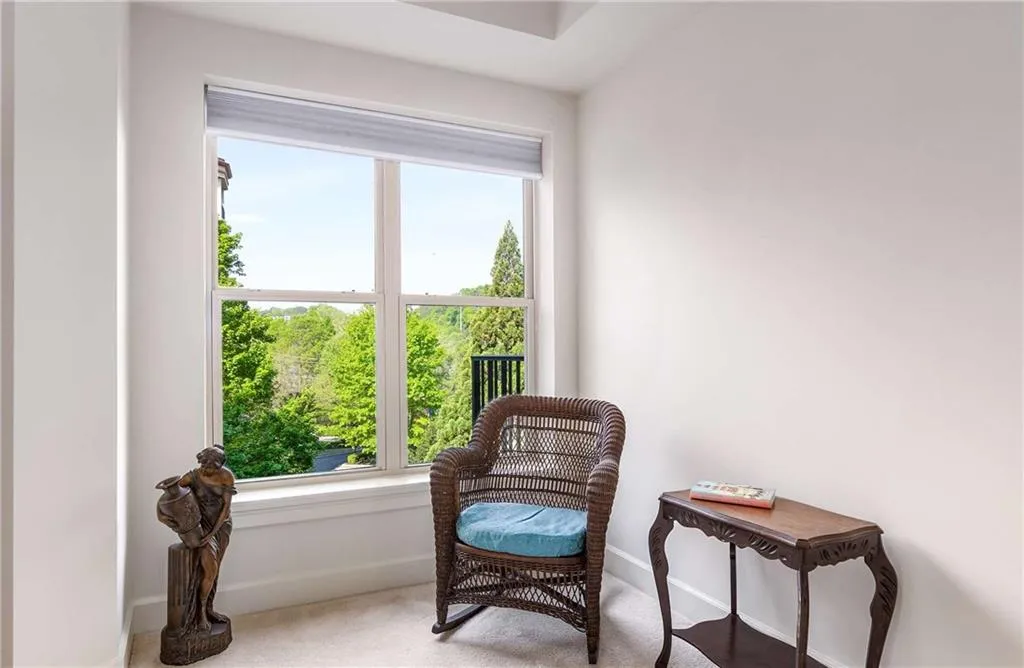 Primary bedroom has a lovely treetop view of the woods on the property.