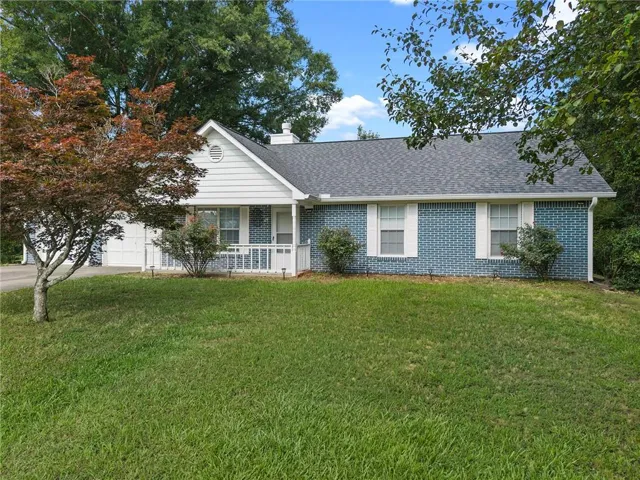 Single-story residence featuring blue brick siding and white trim