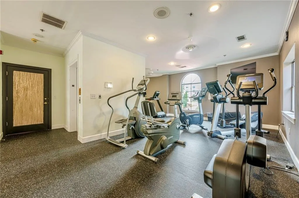 Exercise room featuring crown molding and recessed lighting