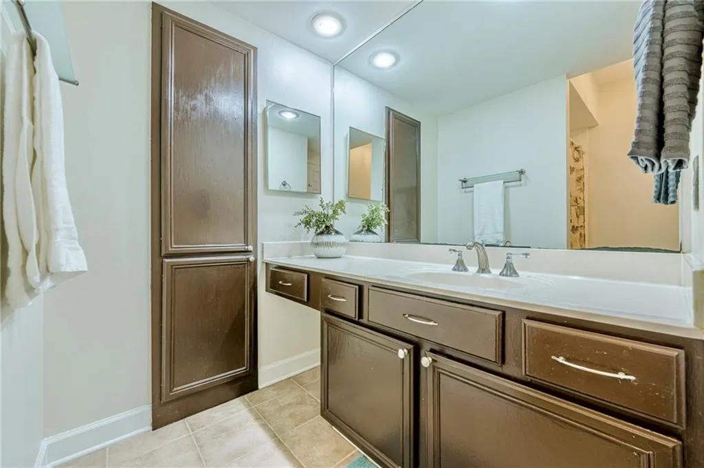 Primary bathroom with vanity and light tile patterned floors