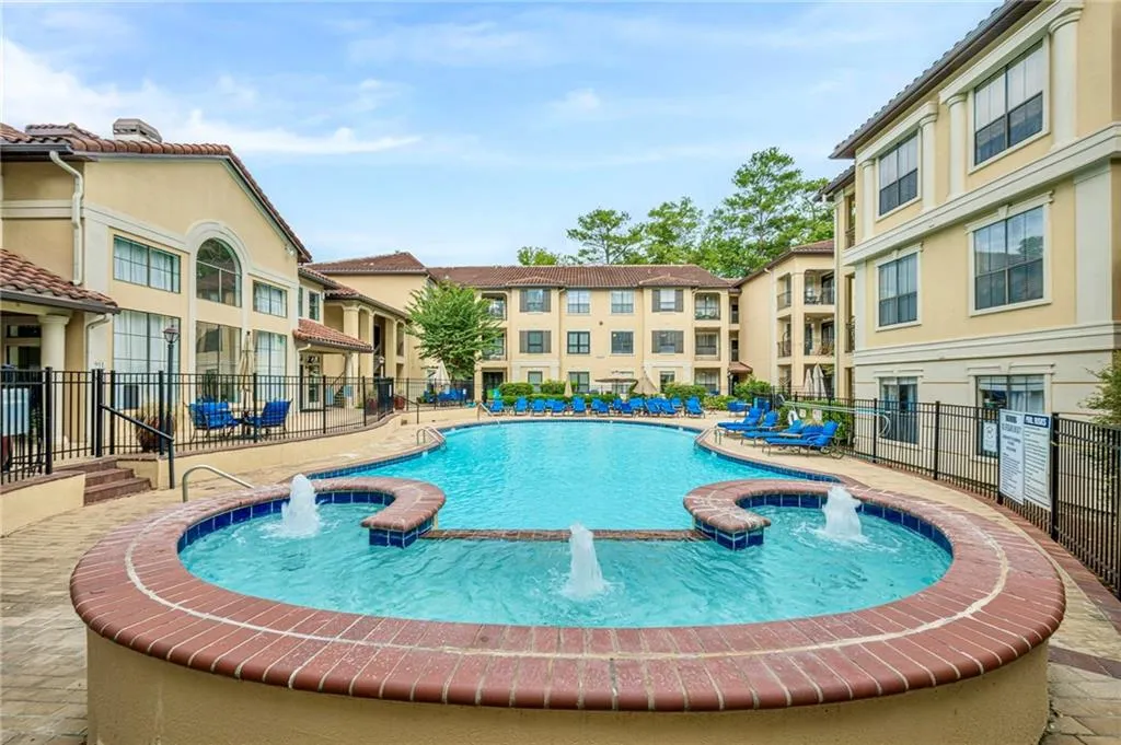 Community pool featuring a patio and a jacuzzi