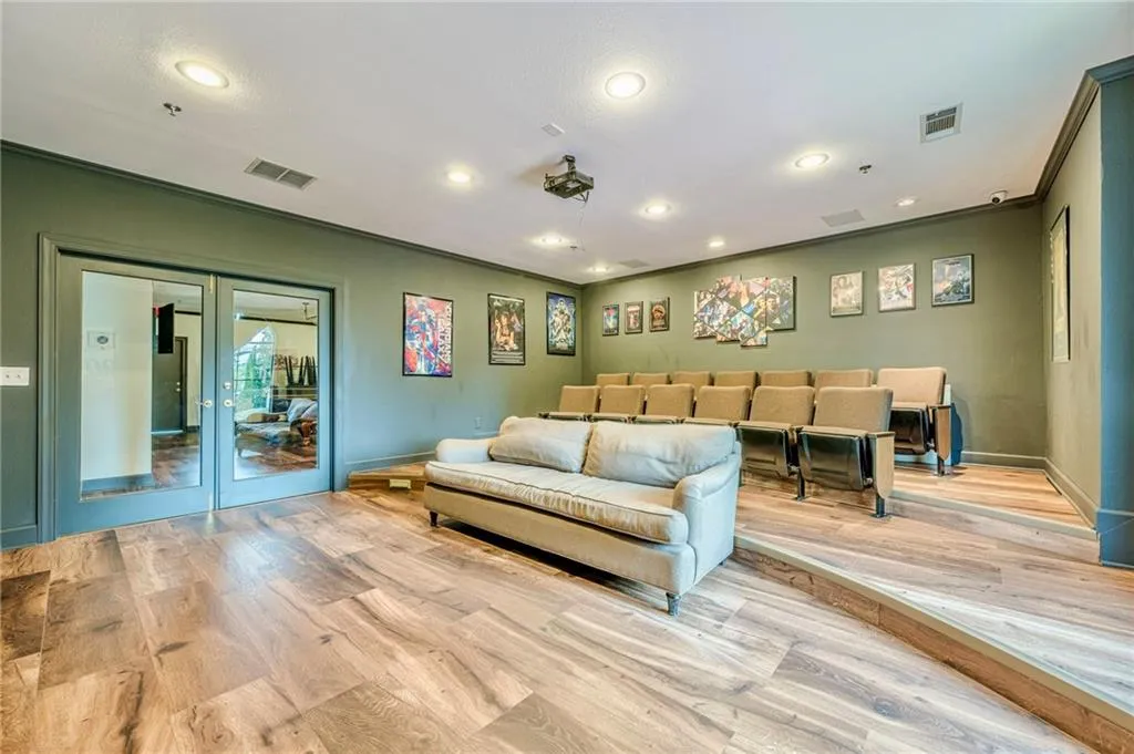 Living area featuring french doors, wood finished floors, recessed lighting, and crown molding