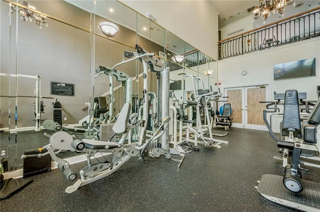 Gym with a high ceiling and a chandelier