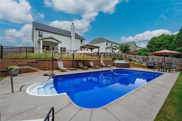 Double layer backyard with fenced in pool