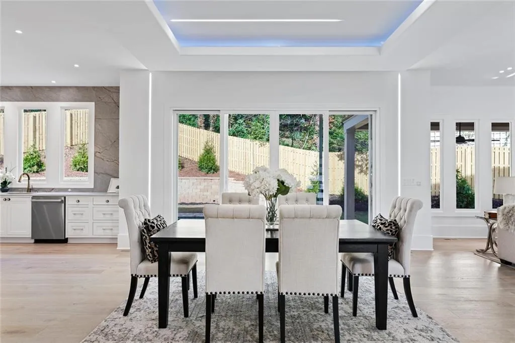 Dining space featuring recessed lighting, light wood-style floors, and a tray ceiling