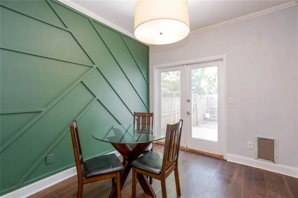 Dining space featuring ornamental molding, heating unit, dark hardwood / wood-style floors, and french doors