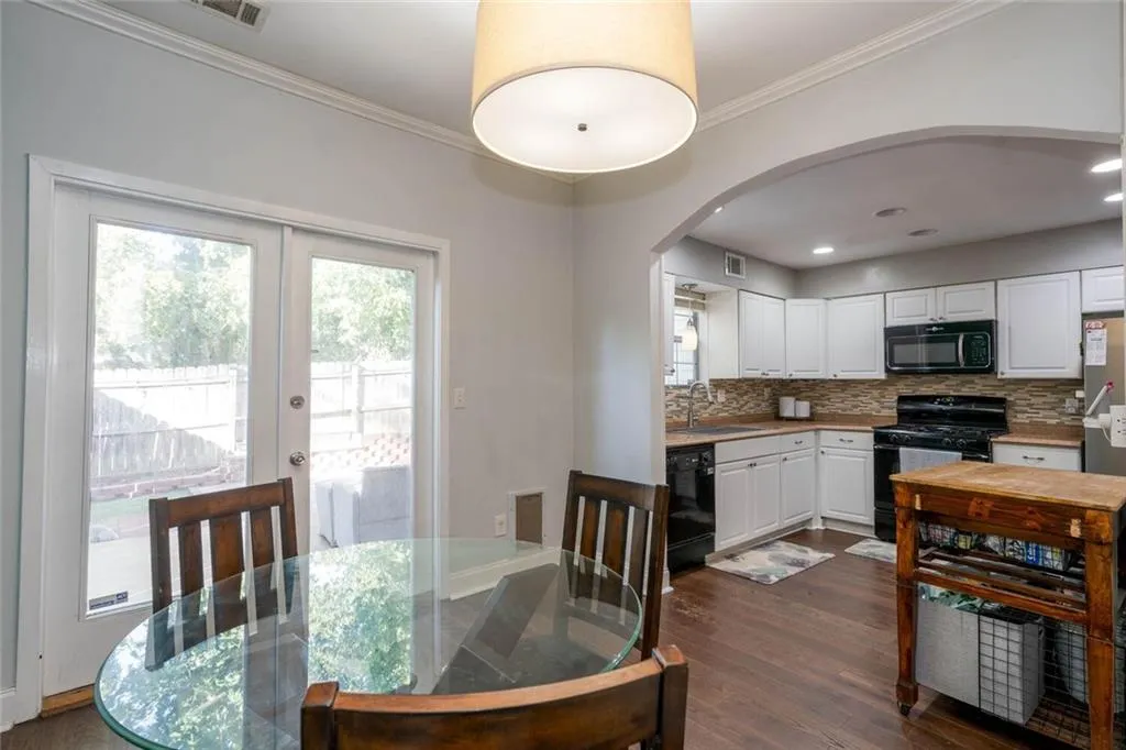 Dining room featuring crown molding, dark hardwood / wood-style floors, and sink