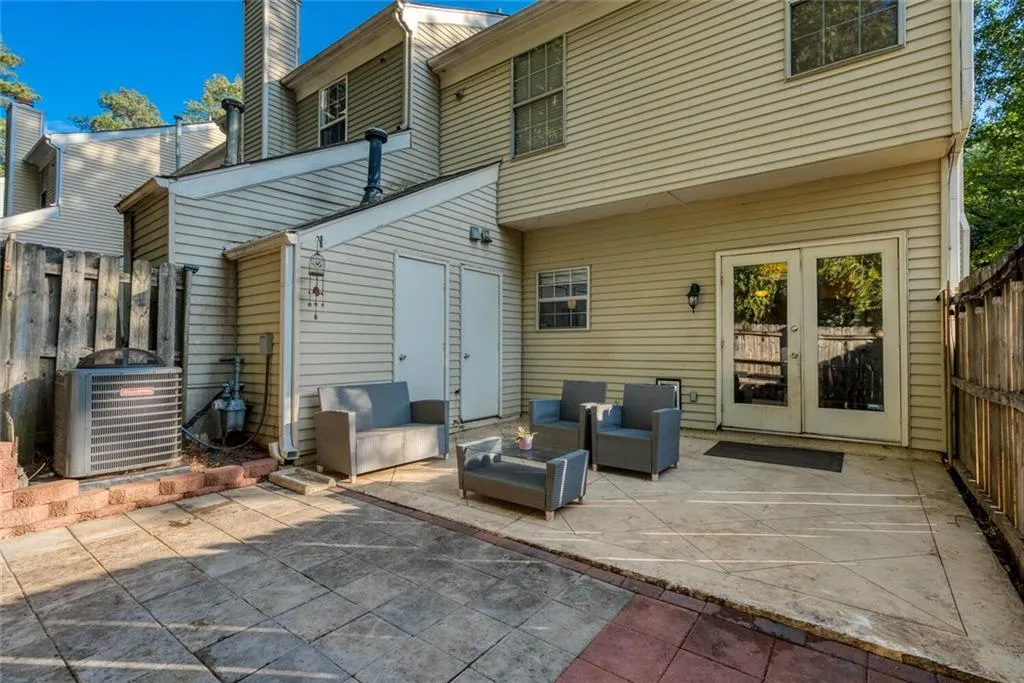 Rear view of property featuring central AC unit, an outdoor hangout area, french doors, and a patio area