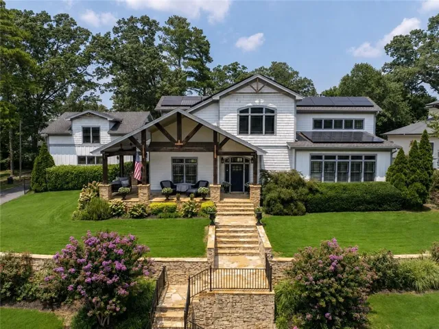 Contemporary-style residence featuring a prominent covered front porch with exposed timber framing