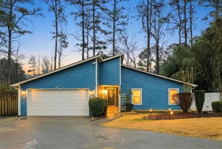 Contemporary blue siding exterior featuring a prominent two-car garage