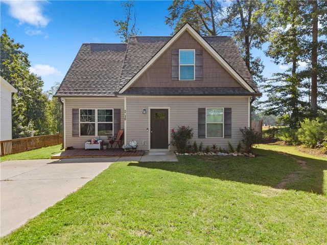 Gable-roof property featuring horizontal siding and decorative board and batten accents